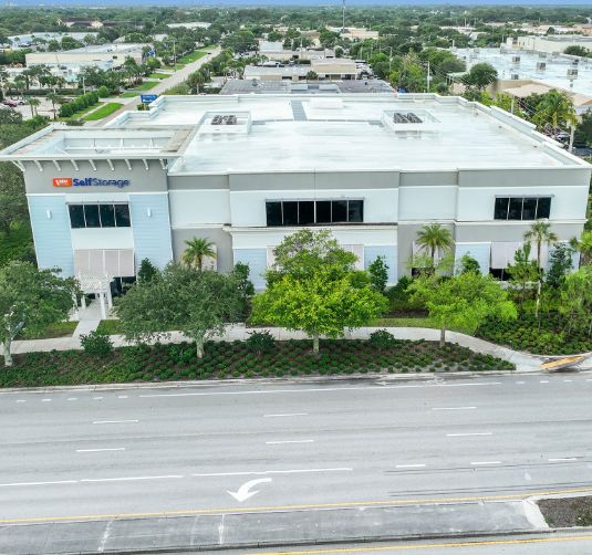 Value Store It modern white storage facility exterior with landscaping and street access.
