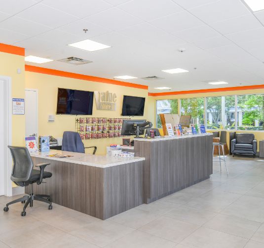 Interior office and leasing area, Value Store It, bright yellow walls with orange trim