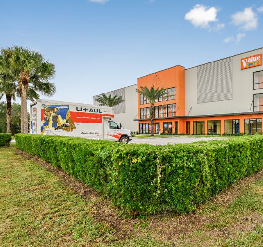 Value Store It facility exterior with U-Haul truck and orange building signage.