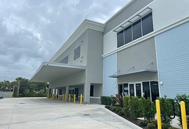 Modern Value Store It facility exterior with drive-up access and yellow bollards.
