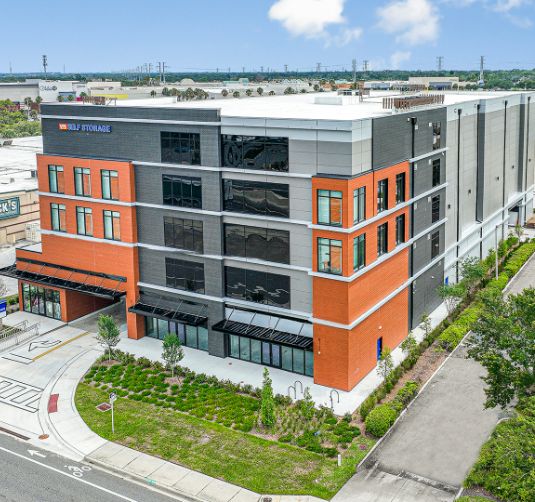 Value Store It modern self-storage facility with orange brick exterior and ground-level access entrance.